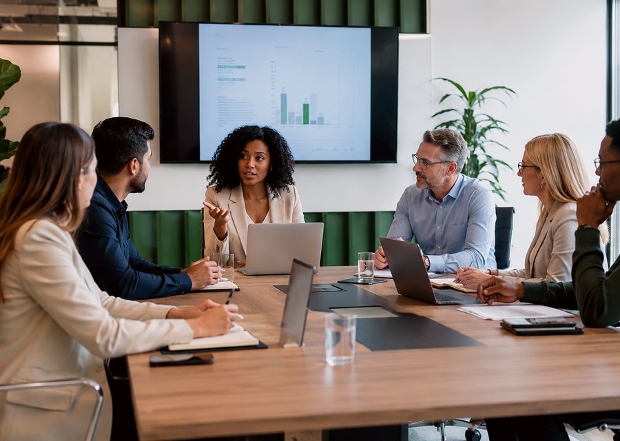 People reviewing meeting questions in a boardroom